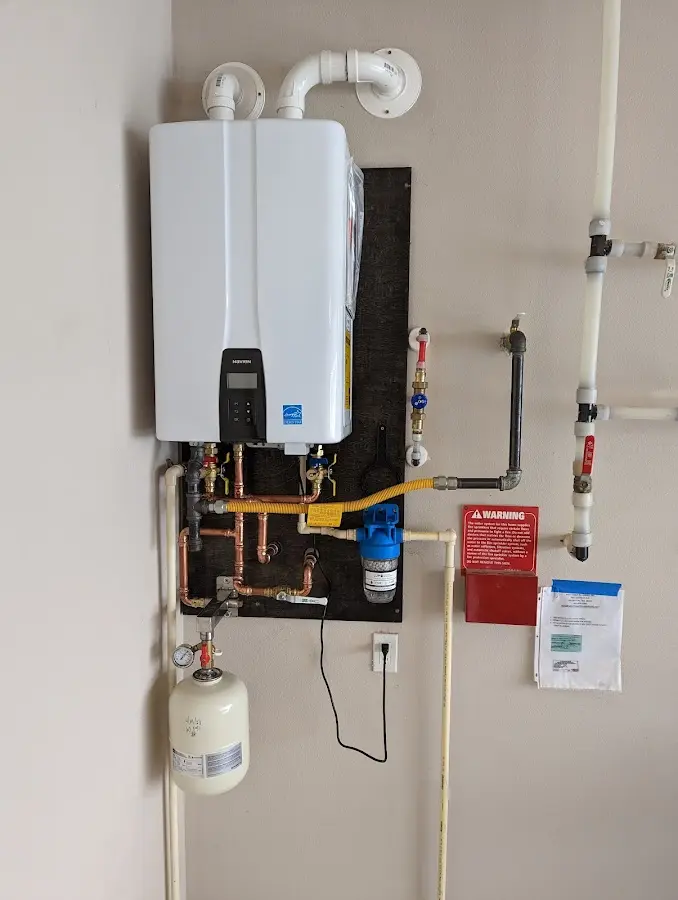 Professional plumber installing copper piping in a Randolph Town home